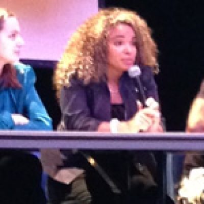 Ereka Howard speaking on stage to an audience